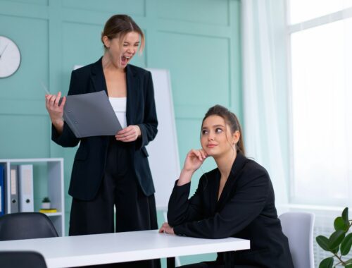 Boss screaming at frustrated employee, bullying and emotional abuse at work