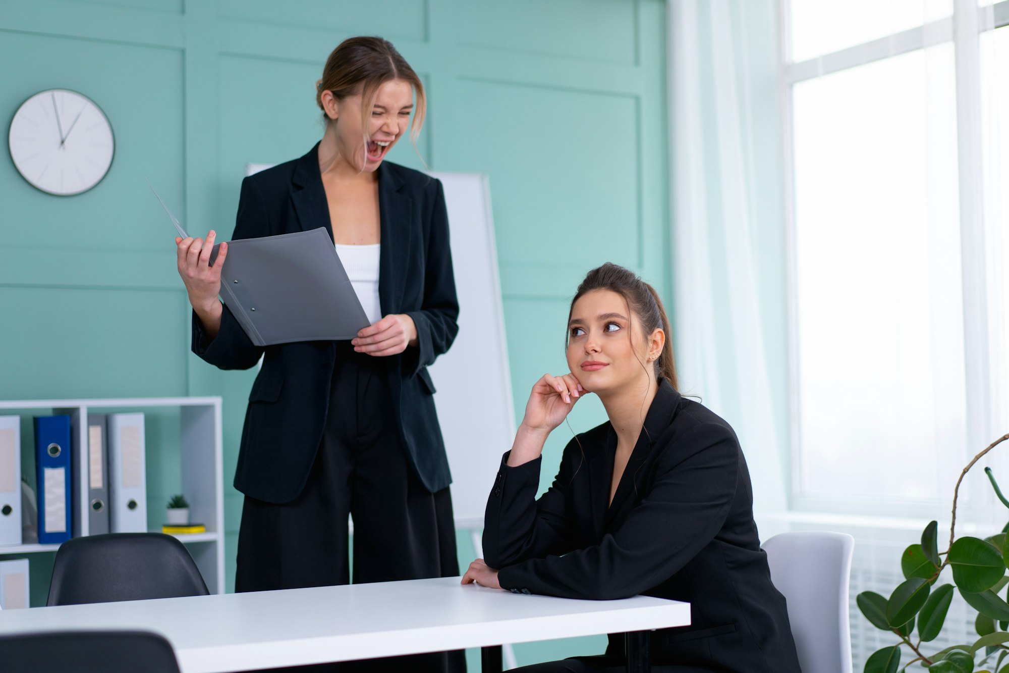 Boss screaming at frustrated employee, bullying and emotional abuse at work