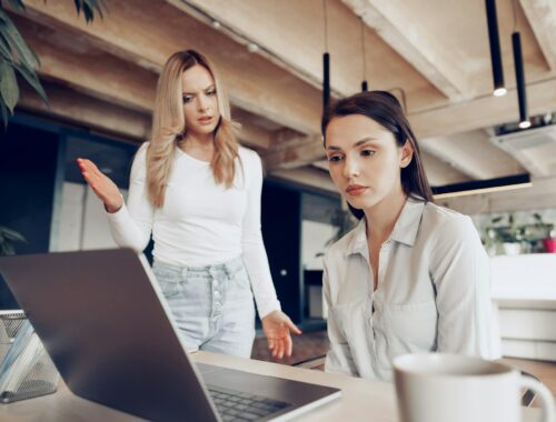 Young female boss scolding her female subordinate for bad work results